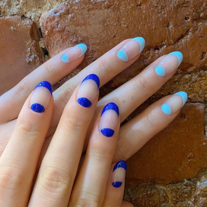 Manicure com espaço negativo: azul escuro por um lado e azul claro no outro
